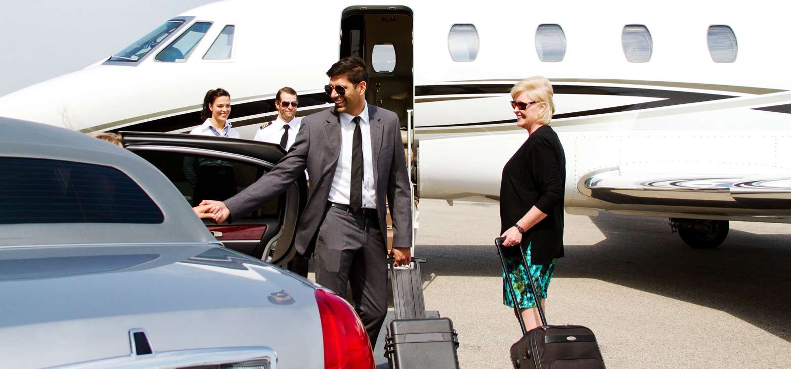 High profile individual leaving his chauffeur to board a private jet, with security personnel present